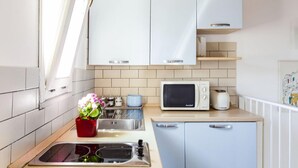 A compact kitchen with white cabinets, a microwave, and a toaster. - Salomone Apartment 13 With Terrace by Wonderful Italy (Syracuse)
