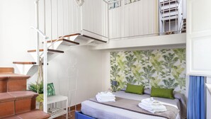 A bedroom with a bed, a staircase, and a view of the outside. - Salomone Apartment 13 With Terrace by Wonderful Italy (Syracuse)