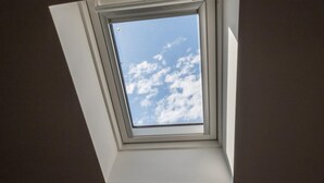 A skylight window with a view of the sky. - La Mansarda di Via Zamboni by Wonderful Italy (Bologna)