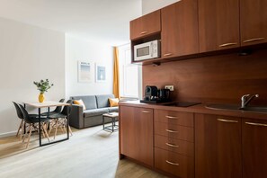 Cozy living space with a kitchenette, dining area, and comfortable seating.