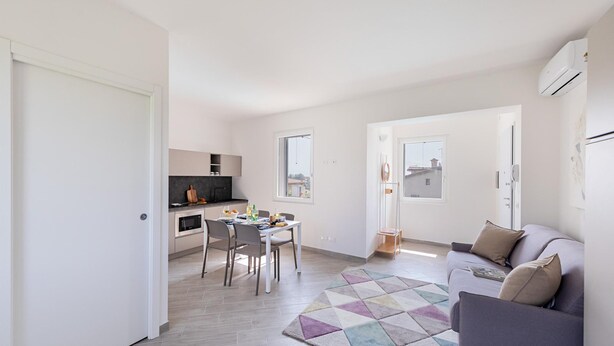 A modern apartment with a kitchen, dining area, and living room. - San Carlo Borromeo 3 by Wonderful Italy (Soiano del Lago)