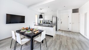 A modern kitchen with white cabinets, a black countertop, and a built-in oven. - Il Quadrifoglio D4 con Piscina by Wonderful Italy (Sirmione)