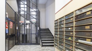 A stairway leading to a mezzanine level with metal railings and a marble floor. - Marvelous Soziglia Apartment by Wonderful Italy (Genoa)