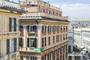 A multi-story building with classical architecture, featuring ornate balconies and large windows. - Via Roma Luxury Apartment by Wonderful Italy (Genoa)