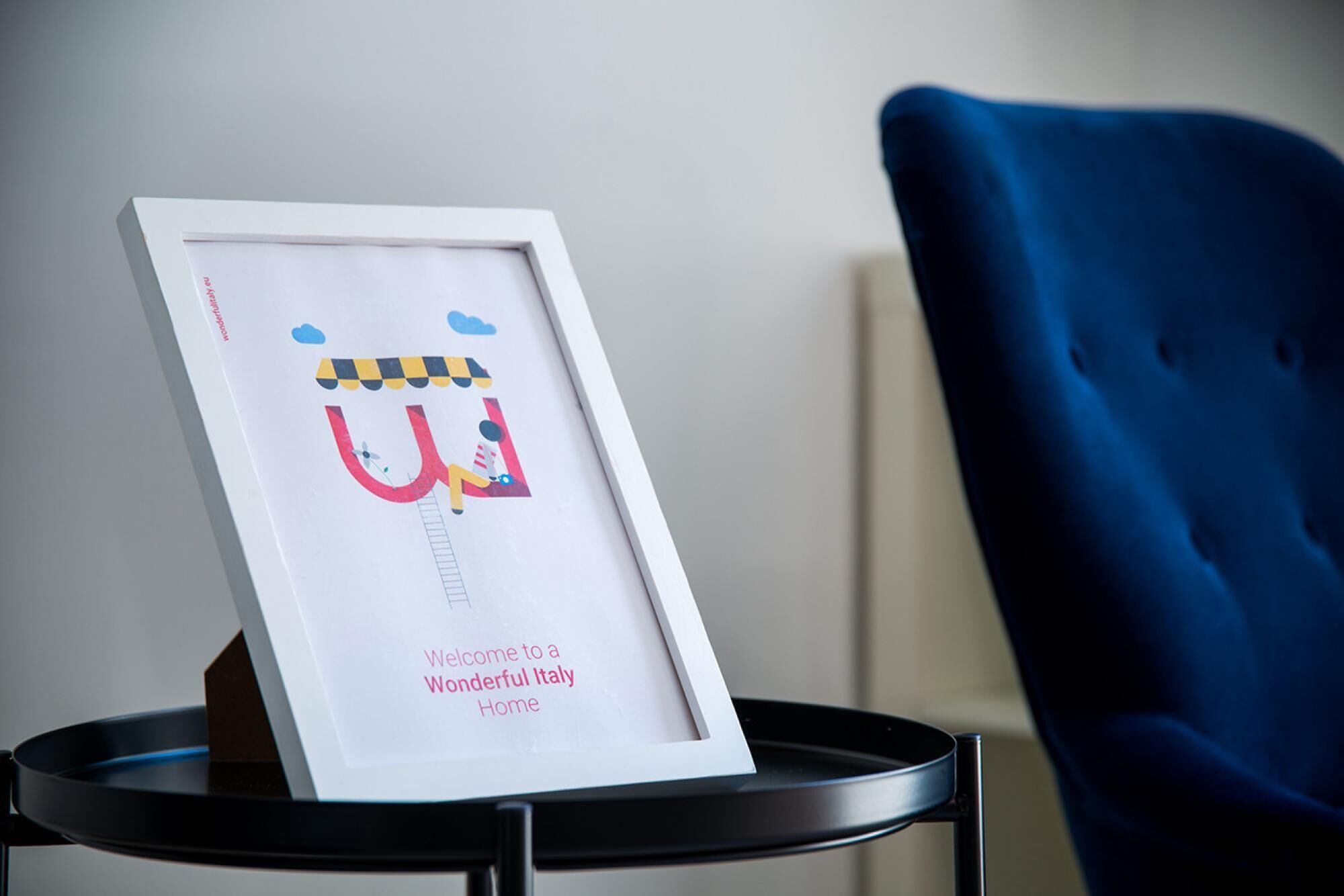 A framed welcome sign with a playful design, placed on a small table.