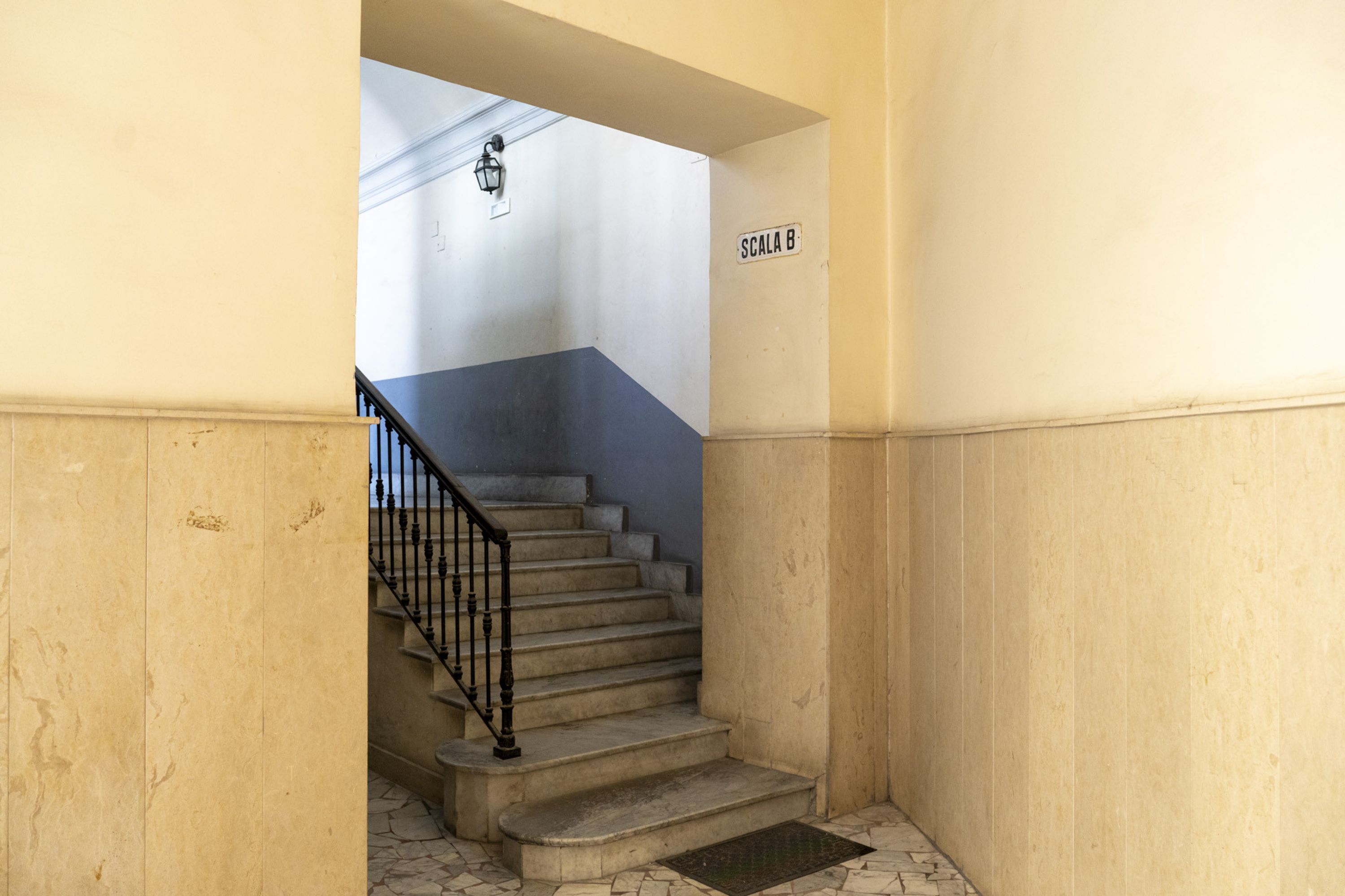 A staircase with a metal railing leading to an upper floor.