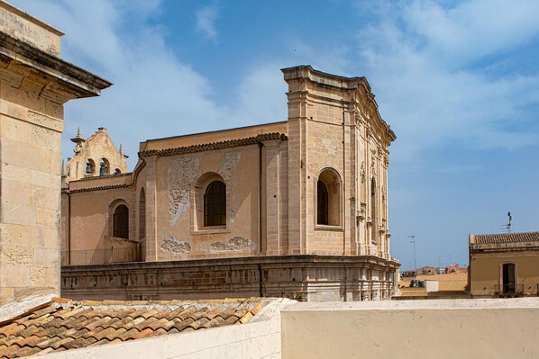 A historic building with arched windows and a bell tower.