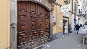 A large wooden door with a sign above it reading "Gransicily".