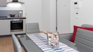 A modern kitchen with a stove, oven, and a hanging light fixture. - Loft del Conte nei Pressi Della Mole by Wonderful Italy (Turin)