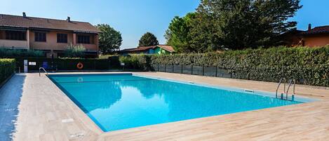 Relax by the pool surrounded by lush greenery and scenic views.