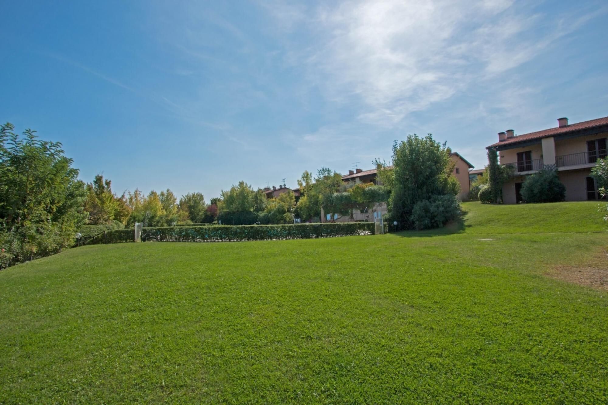 A grassy area with a building in the background.