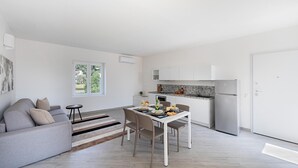 A modern apartment with a living area, dining space, and kitchen. - San Carlo Borromeo 2 by Wonderful Italy (Soiano del Lago)