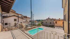 A residential area with a swimming pool, a crane, and a view of neighboring houses. - San Carlo Borromeo 2 by Wonderful Italy (Soiano del Lago)