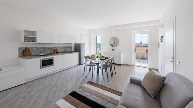 A modern apartment with a kitchen, dining area, and living room. - San Carlo Borromeo 2 by Wonderful Italy (Soiano del Lago)