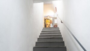 A staircase leading to a room with a large poster on the wall. - O Panaro ai Quartieri Spagnoli (Naples)