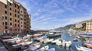 A marina with various boats docked, surrounded by buildings. - Nel Cuore del Borgo di Camogli by Wonderful Italy (Camogli)