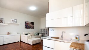 A modern kitchen with white cabinetry, a built-in oven, and a wooden countertop. - Agatea a due Passi dal Duomo by Wonderful Italy (Catania)