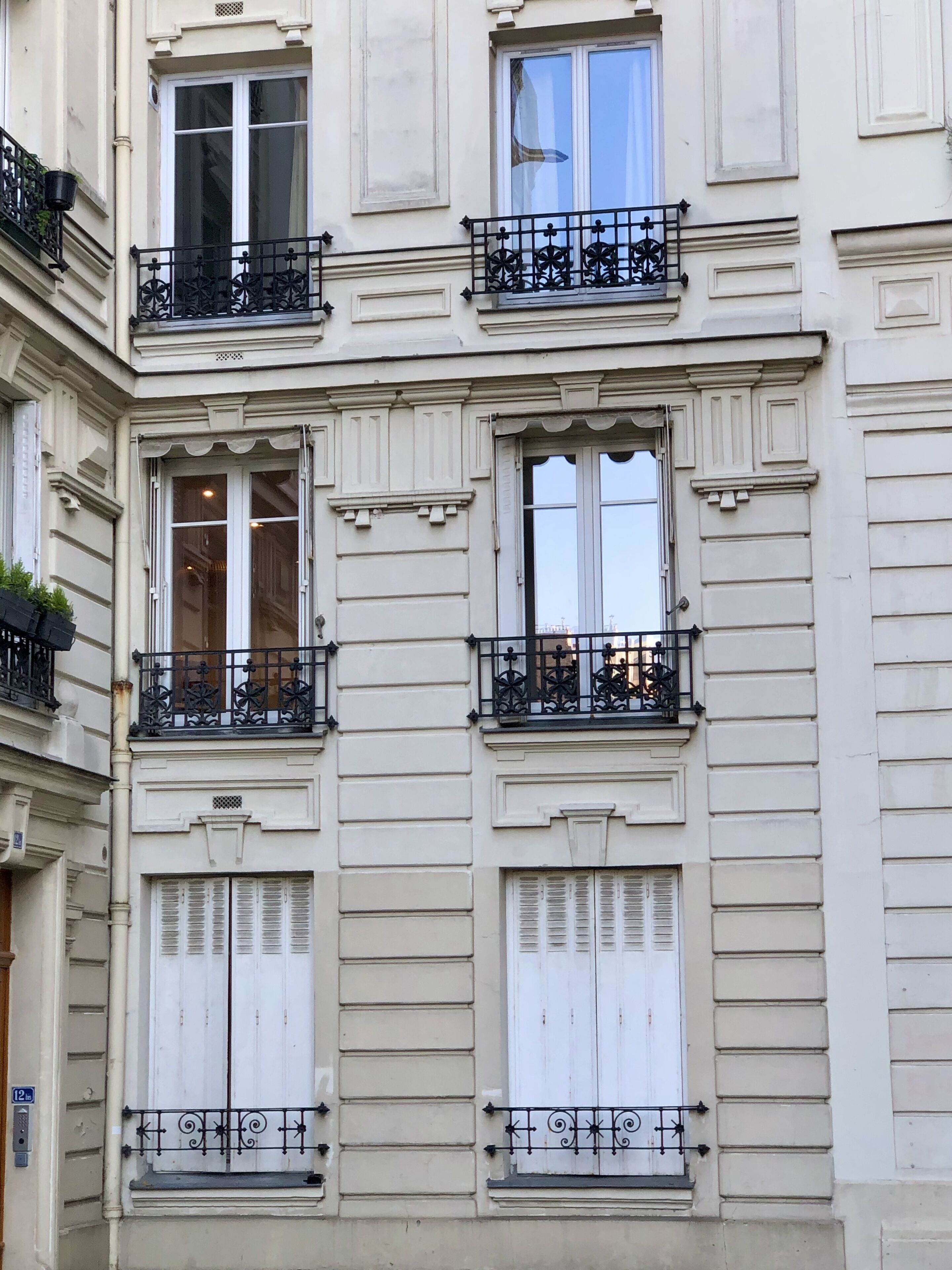 A multi-story building with balconies, large windows, and a classic architectural style.