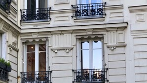 A multi-story building with balconies, large windows, and a classic architectural style. - New architect's'apartment located in the heart of the village of Montmartre (Paris)