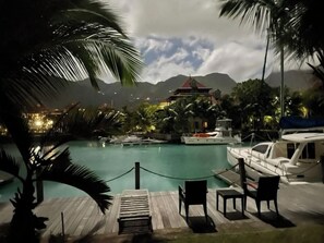 Relax by the pool surrounded by lush greenery and tranquil surroundings.