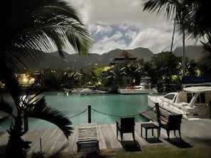 Relax by the pool surrounded by lush greenery and tranquil surroundings.