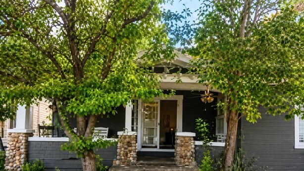 A house with a porch, stone steps, and a tree in front. - Historic Valier Lodge near Lake Francis (Valier)