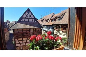 Traditional half-timbered building with exposed brick infill and a steeply pitched roof.