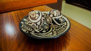 A plate with decorative items on a wooden table.