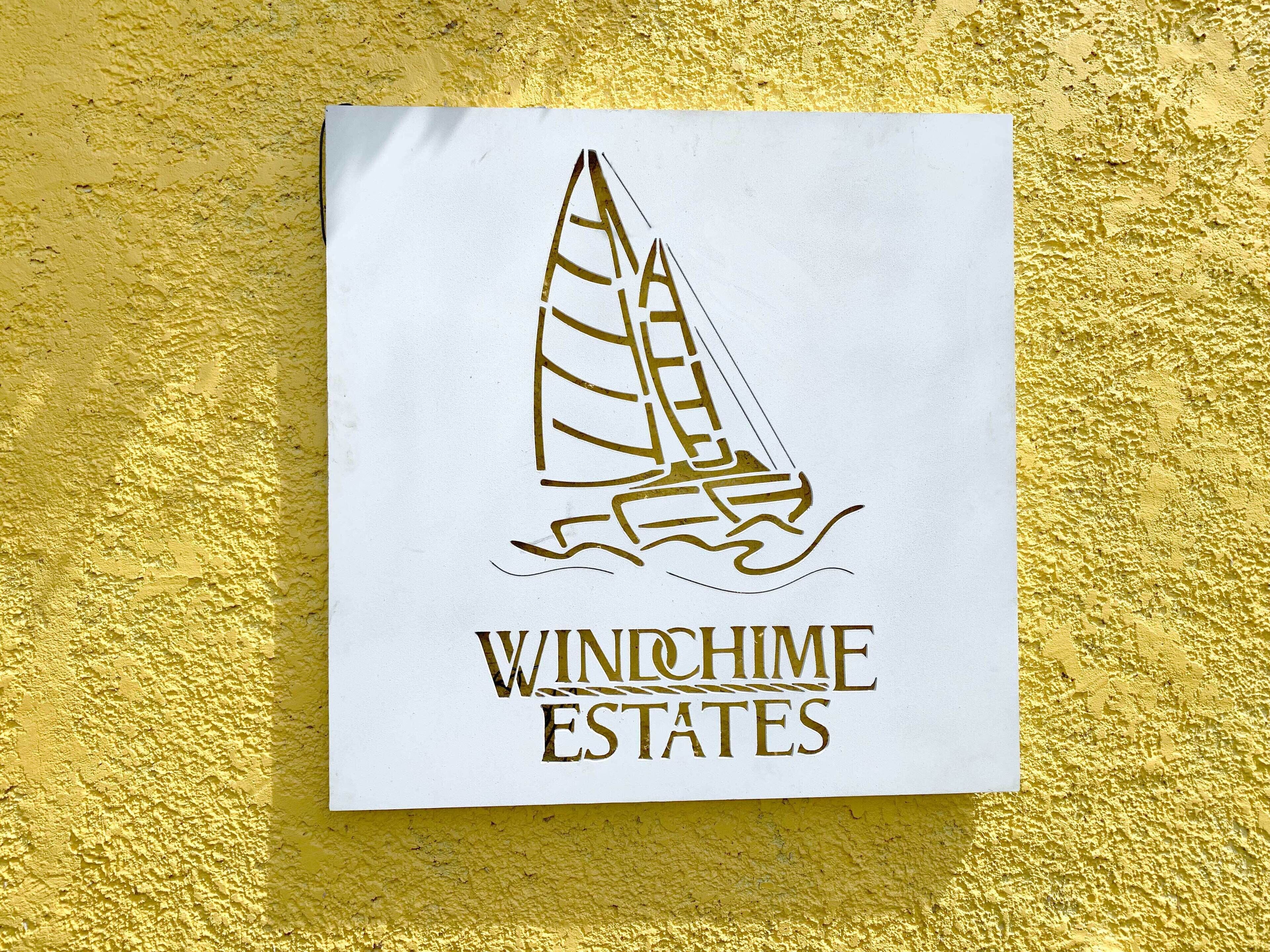 A logo with a sailboat and the text "WINCHIME ESTATES".