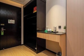 A modern kitchen with a wooden countertop, a sink, and a trash bin. - Jewel Business Hotel (Kaiping)