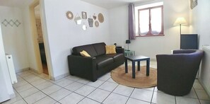 Relax in this stylish living room with a leather sofa, coffee table, and armchair.
