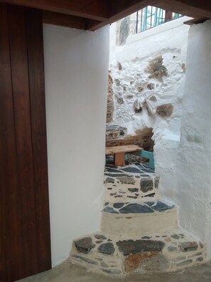 Traditional charm fills this cozy space with exposed stonework and rustic details.