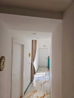 Stylish hallway with white doors and a gold wall decoration.