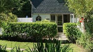Ein Haus mit dunklem Dach, einer sichtbaren Haustür und einem Schild mit der Aufschrift "WILLOW".