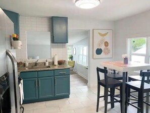 Enjoy meals in the kitchen with an oven and refrigerator, and dine at the adjacent table.