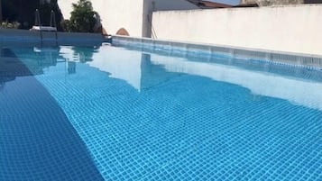 Seasonal outdoor pool, pool umbrellas, pool loungers