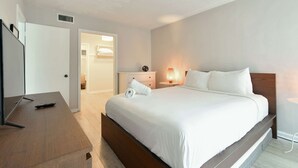 A hotel room with a bed, bedside table, lamp, and a TV. - ✨One Bedroom Stunning River Views at Fort Lauderdale (Fort Lauderdale)