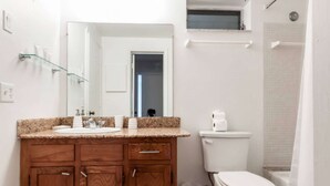 A bathroom with a wooden vanity, a toilet, a glass shower enclosure, and a mirror. - ✨One Bedroom Stunning River Views at Fort Lauderdale (Fort Lauderdale)