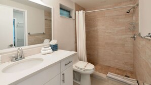 A bathroom with a sink, mirror, toilet, shower, and a towel rack. - ✨Brand New Designer Two Bedroom Apartment at Fort Lauderdale (Fort Lauderdale)