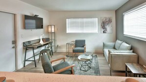 A living room with a sofa, armchairs, a coffee table, a TV, and a window with blinds. - ✨ One Bedroom Chic and Cool - Large (Full Kitchen) (Miami)