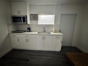 Fridge, microwave, stovetop, coffee/tea maker