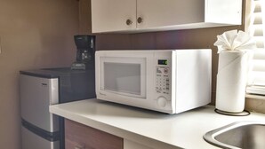 A kitchenette with a microwave, coffee maker, and a paper towel holder. - ✨Wynwood, style new trendy studio 1456R (Miami)