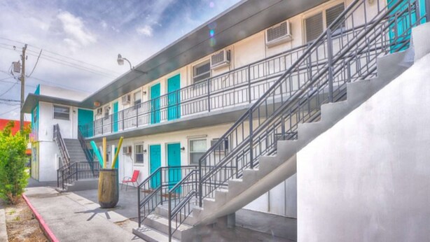 A multi-story building with a staircase leading to the upper floor. - ✨Designer Chick Flat w/Full Kitchen (Miami)