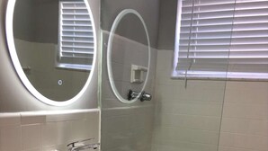 A bathroom with a white sink, a mirror, and a shower area. - ✨Awesome Designer Krymwood Flat (Miami)