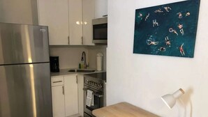 A compact kitchen with a refrigerator, stove, microwave, and sink. - ✨New Two Bedroom plus Free Parking (Miami)