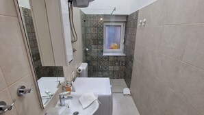 A modern bathroom with a sink, mirror, and a window. - Old bridge (Mostar)