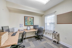 A well-lit office space with a desk, two monitors, a printer, and a telephone. - Condo on the beach! 2/2 with two pools, cafe and tiki bar! Sunset Vista Resort (Treasure Island)