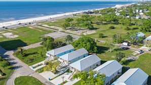 A residential area with houses, a beach, and a road. - Brand new home, 1 block from Beach (Gulfport)