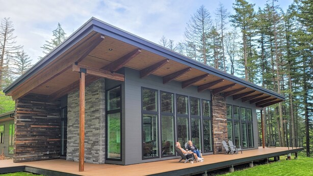 A modern house with large windows, a deck, and a stone exterior. - Amazing New 5 Bed Home next to the Columbia River. Sleeps 10 adults & 6 Kids (Stevenson)