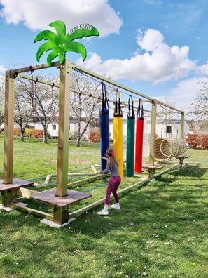 A playground with a swing set and a climbing structure.